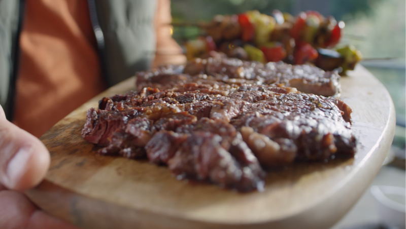 Grilled food served on a wooden board