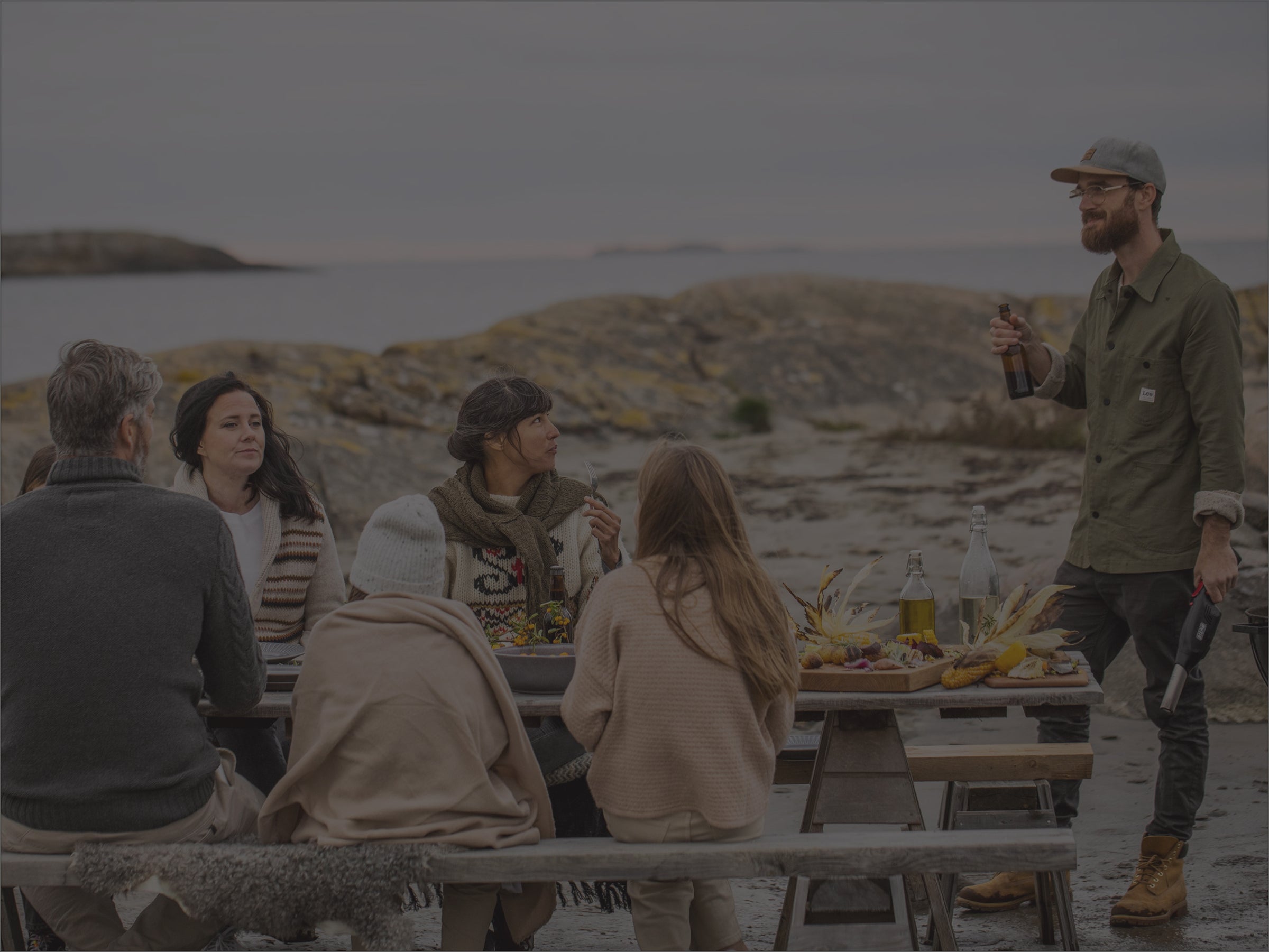 Family hanging out by the sea at a table with Bison Airlighter