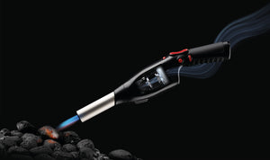 Airlighter torch emitting flames on coal on a black background