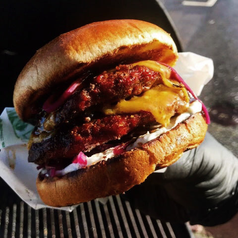 Close up picture of a burger in a hand