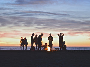 Picture of people enjoying an evening campfire by the sea