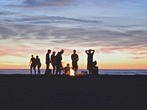 Picture of people enjoying an evening campfire by the sea