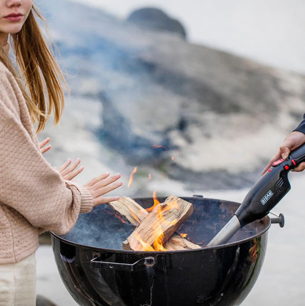 Girl warming her hands over a fire with Airlighter being used