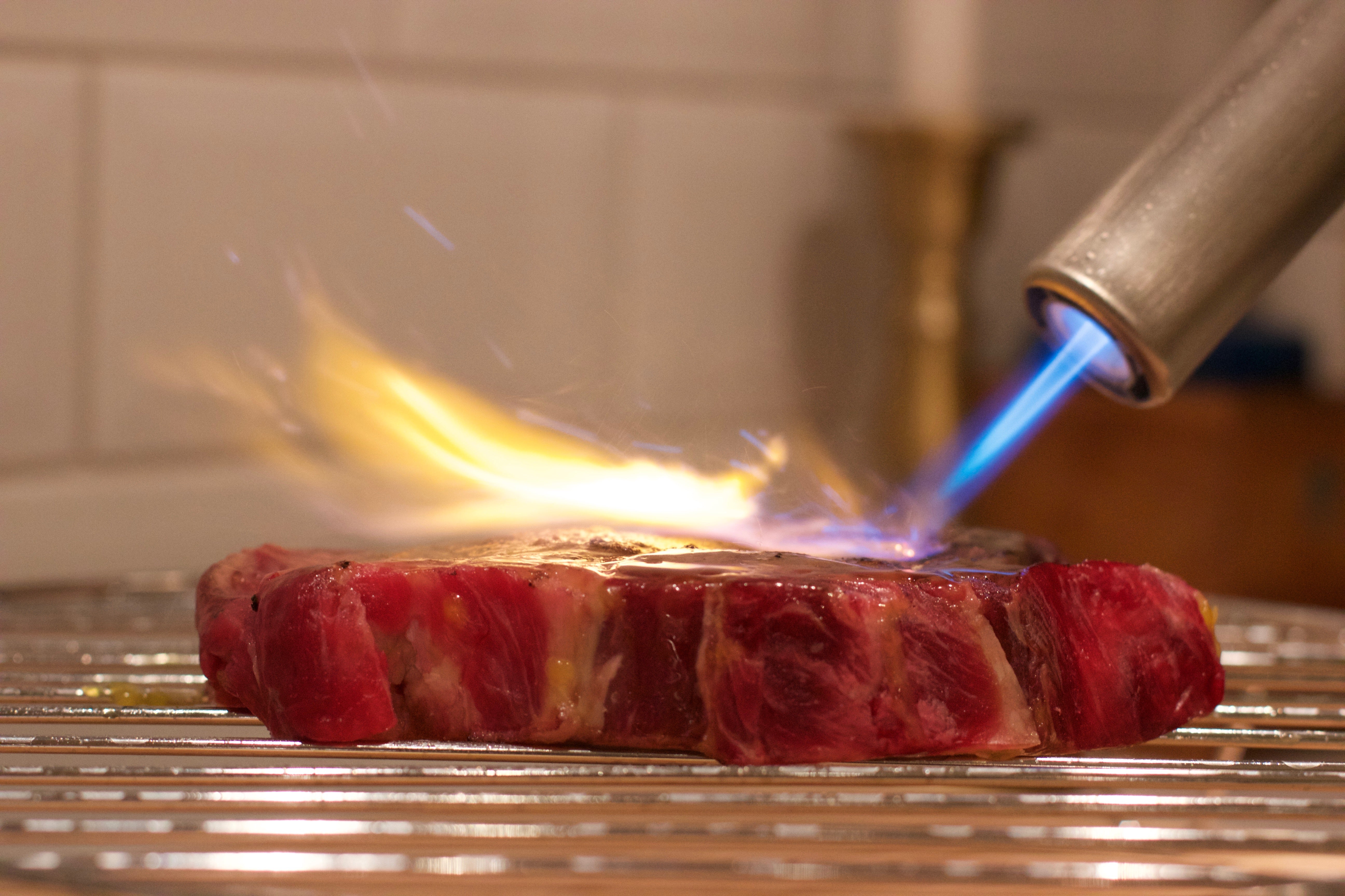 Image of Airlighter flame on searing meat. 